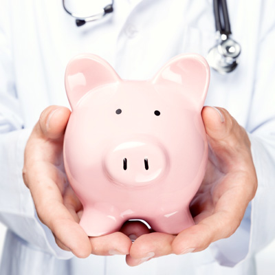 a doctor holding a pink piggy bank