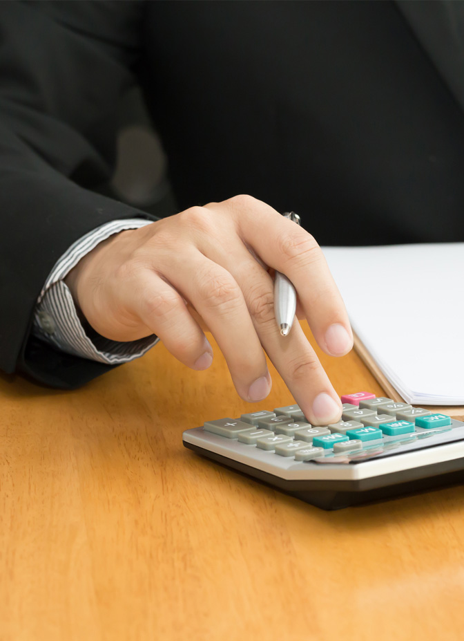 A businessman using a calculator