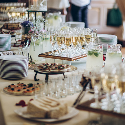 a long table in hotel served with champagne and dessert, and with plates ready