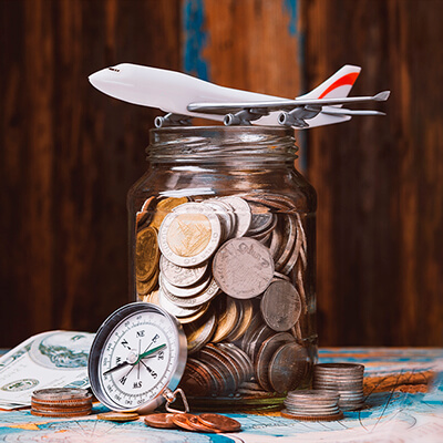 Different Currency coins and airplane figure