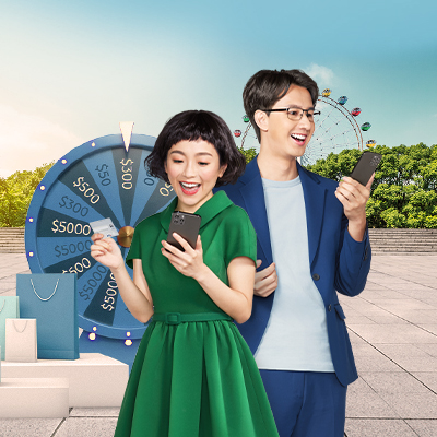 One man who wearing blue suit and one lady who wearing green one piece dress are standing in front of ferris wheel and using their mobile device with smile