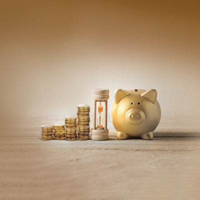 Stack of coins with hourglass and pig display