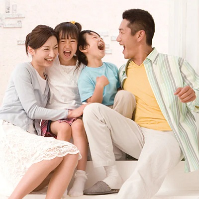 mother and father and their two children laughing
