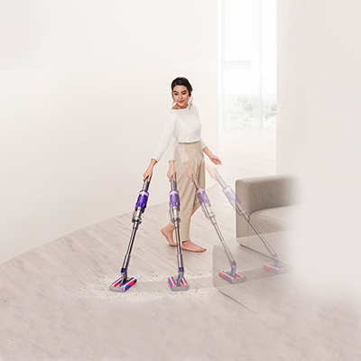 The lady cleaning floor using dyson device
