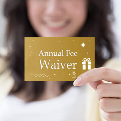 a hand holding an annual fee waiver coupon to waive the first year annual fee