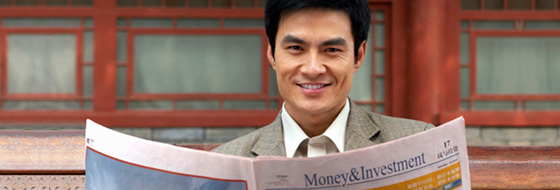 man holding a news paper printed with "Money&Investment"