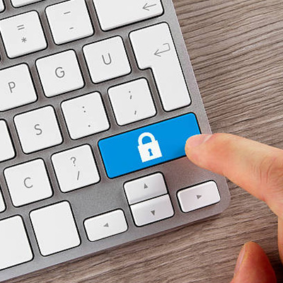 tabbing a blue key with lock icon on keyboard, to authorise and encrypt for online banking services