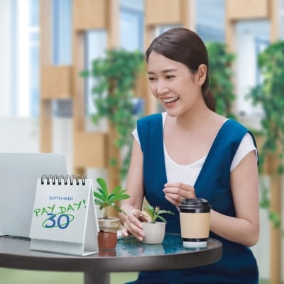 lady is working with green plants in office with smile