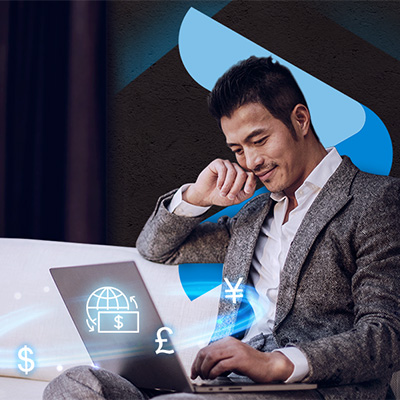 a business man using laptop with digital image of worldwide currency symbols