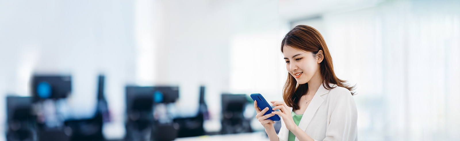 Brown hair woman using mobile phone in office