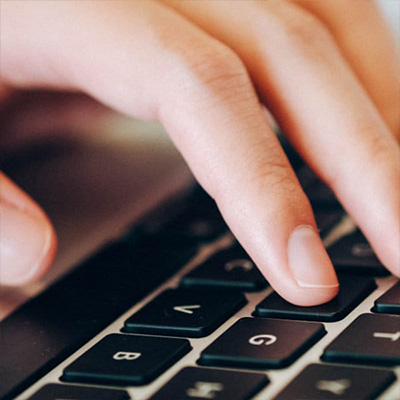 fingers tabbing on laptop keyboard