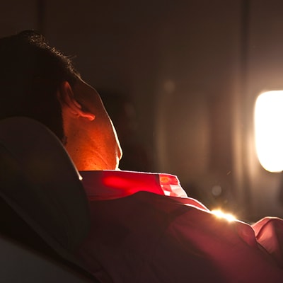 A flight passenger relaxing as he is covered with overseas air accident insurance