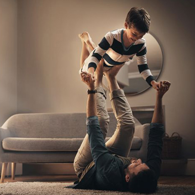 The best way to bond is through play a young man enjoying playtime with his son at home