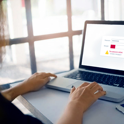 Woman using empty screen laptop computer on desk