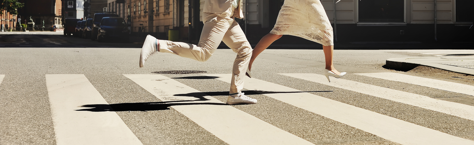 Married couple running across the road