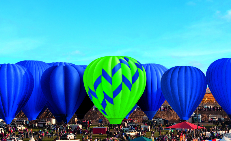Hot air balloon floating above others at festival, Albuquerque, New Mexico, United States