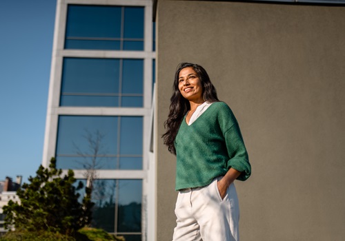 Joyful indian woman relishing modern terrace ambiance