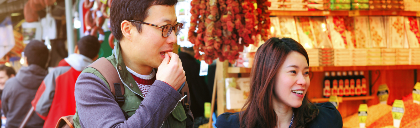 Asian couple shopping at a local market when on holiday