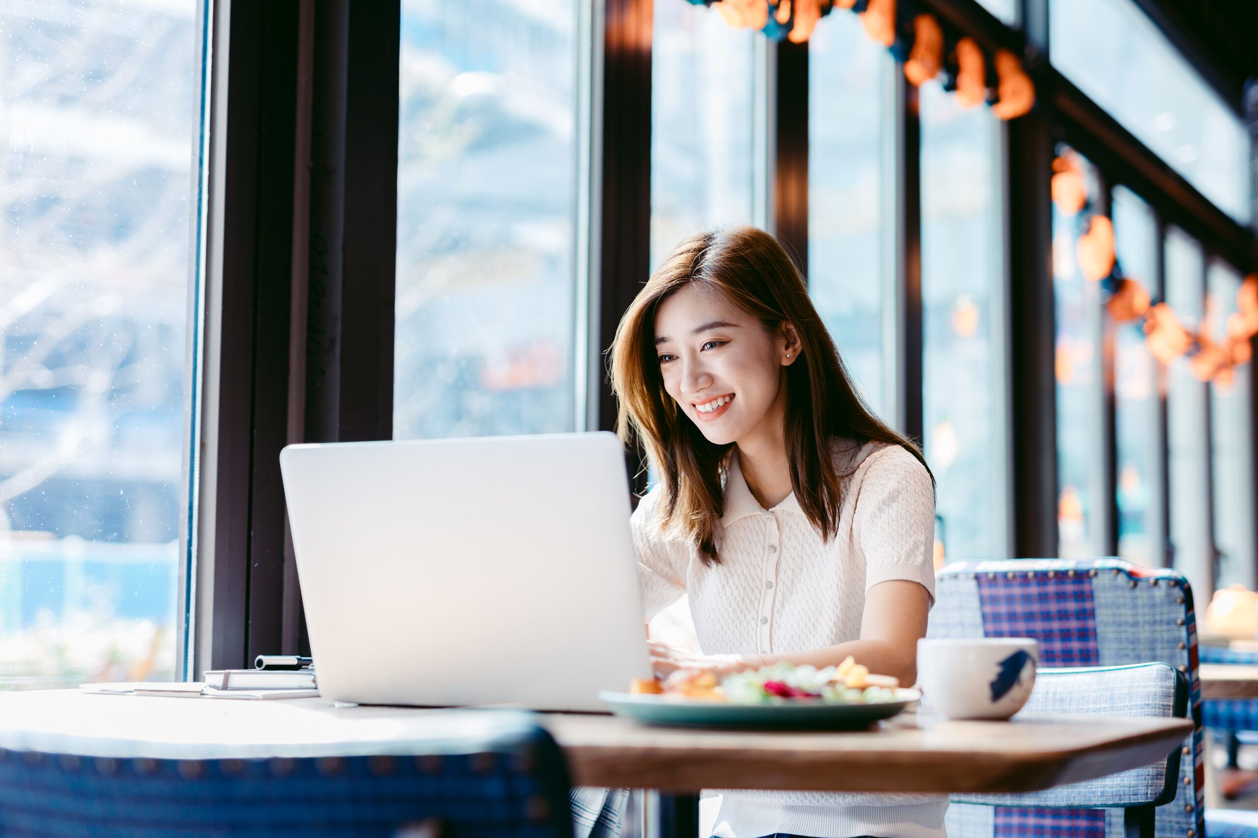 Asian woman working laptop at cafe